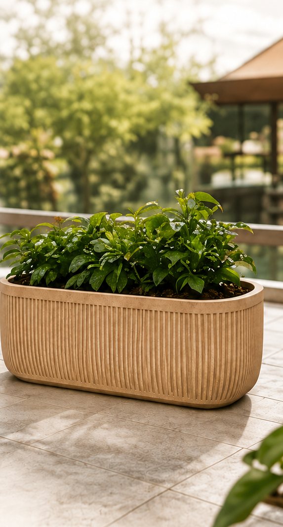 Luna oval ribbed planter box in sandstone on a balcony